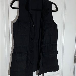 Black vest with pockets, tie, and hidden buttons